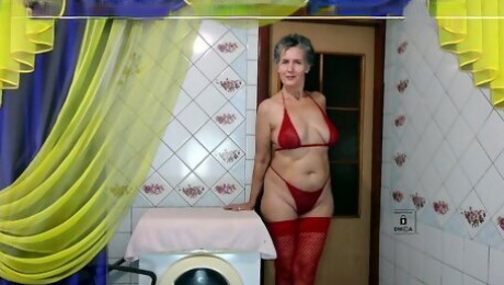Hot housewife Lukerya again in red lingerie gives a smile and cheers up her fans by chatting with flirting online on a w